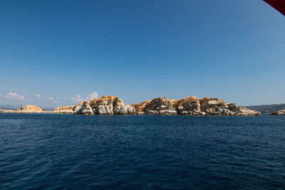 Scenic view of sea against clear blue sky