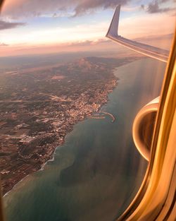 Aerial view of cityscape against sky during sunset