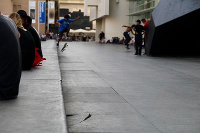 People walking on footpath in city