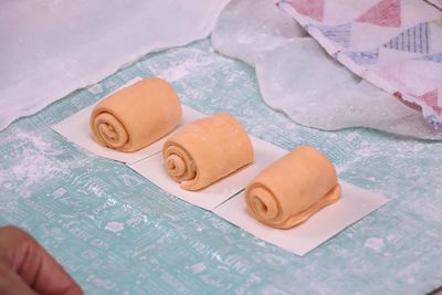 Close-up of rolled dough side by side on table