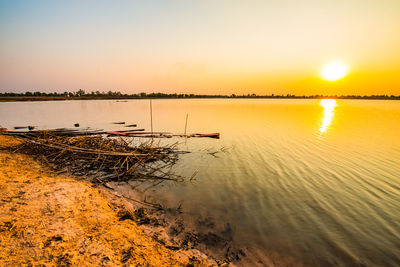 Scenic view of lake against sky during sunset