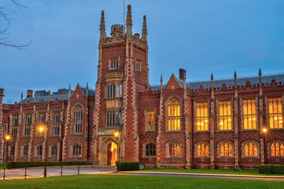 The imposing main building of the queens university in belfast at twilight