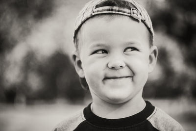 Close-up of smiling boy looking away