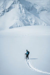 Man skiing on snow covered landscape