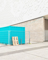 Empty chairs against wall in building