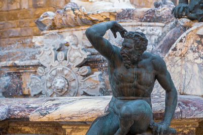 Detail of a statue of the satyr of the fountain of neptune in florence