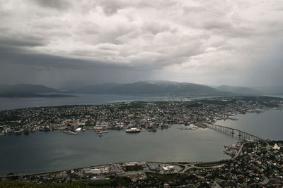 High angle view of townscape by sea against sky