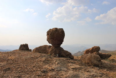 Rock formations on landscape against sky