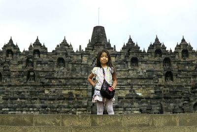 Full length of woman standing by railing