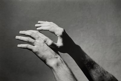 Close-up of person hand against gray background