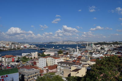 High angle view of townscape by sea against sky