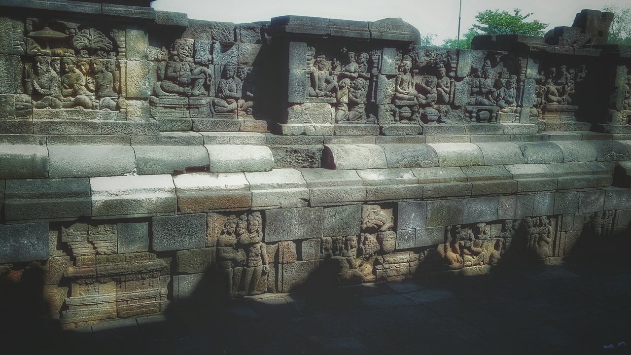 architecture, built structure, building exterior, history, art and craft, wall - building feature, old, art, low angle view, creativity, the past, place of worship, religion, ancient, carving - craft product, day, old ruin, wall, stone wall, temple - building