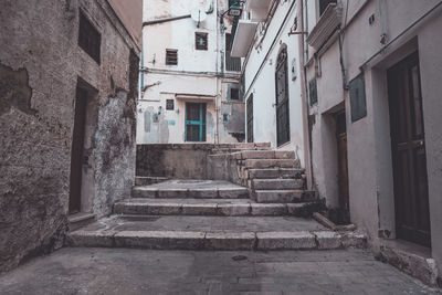 Empty alley amidst buildings in town