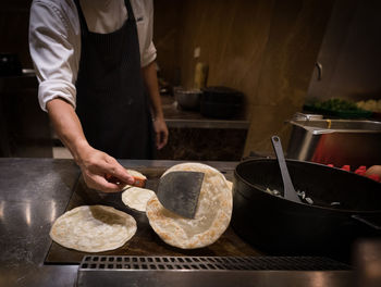 Midsection of man preparing food on table