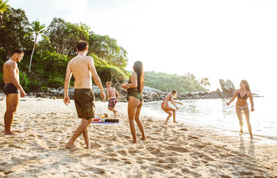 Friends enjoying at beach during summer