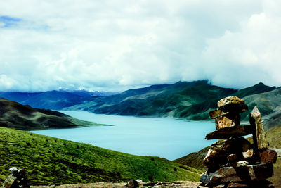 Statue by mountains against sky