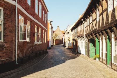 Empty alley amidst buildings in city