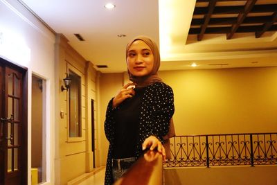 Smiling beautiful woman standing at home