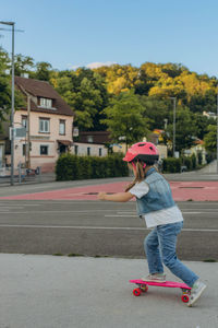 Rear view of woman walking on road