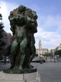 Close-up of statue against cloudy sky