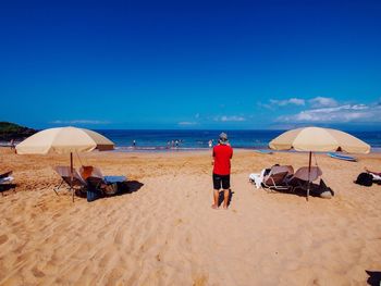 Scenic view of beach against blue sky