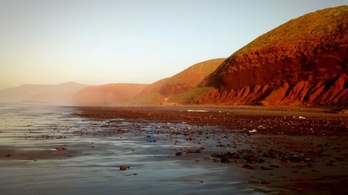 Scenic view of sea against clear sky during sunset