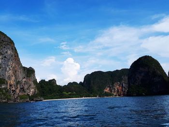 Scenic view of sea and mountains against sky