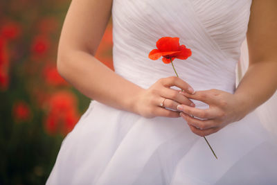 Midsection of woman holding flower bouquet