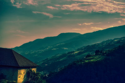 Sunset over the mountains in trentino alto adige with vineyards and orchards