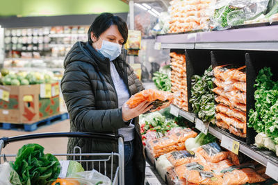 Woman wearing mask shopping in store