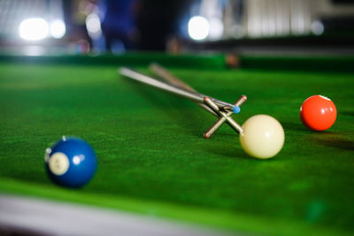 Midsection of man playing pool at club