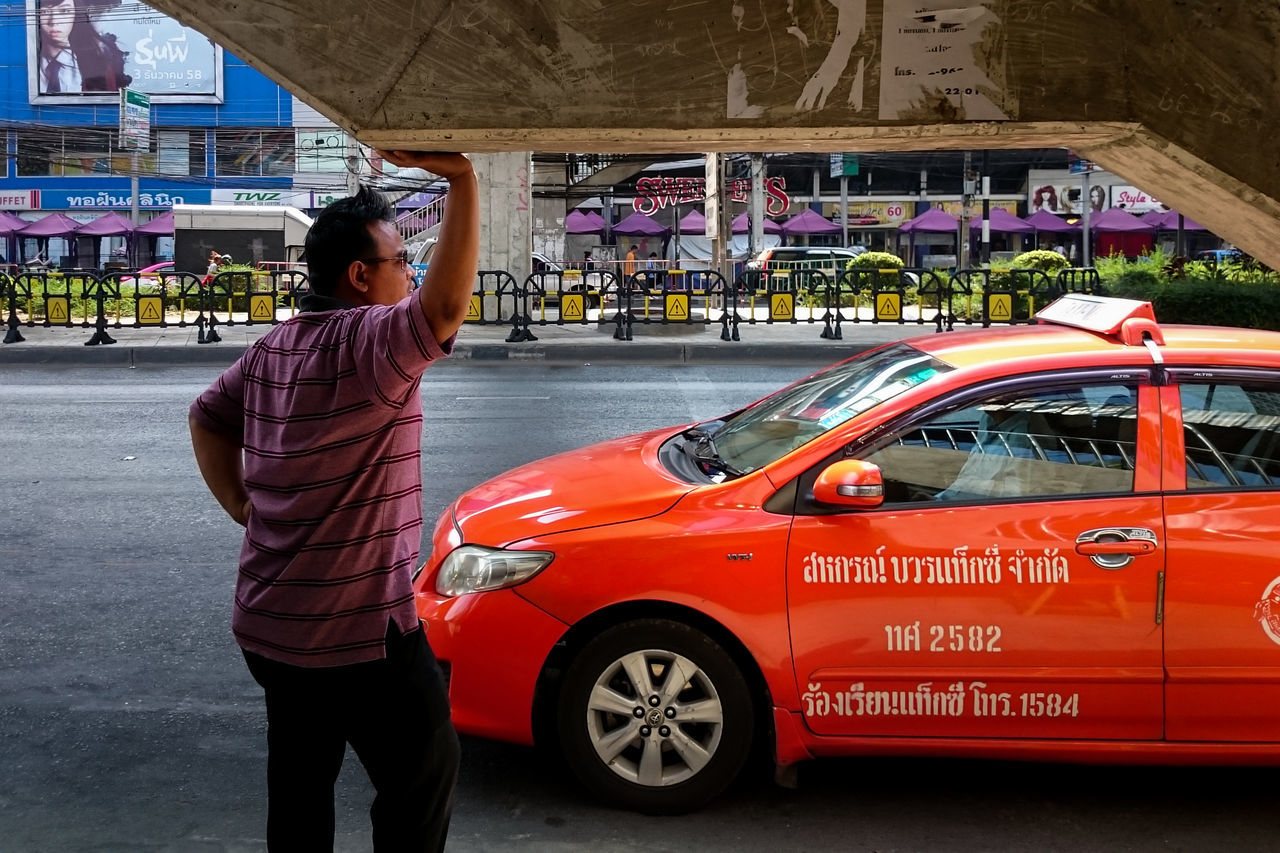 transportation, mode of transport, land vehicle, bicycle, lifestyles, leisure activity, street, car, text, travel, side view, casual clothing, men, standing, riding, rear view, communication, road