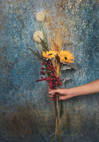 Close-up of hand holding flower bouquet