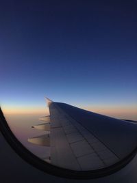 Close-up of airplane wing against clear sky