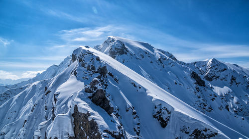 Scenic view of snowcapped mountains against sky