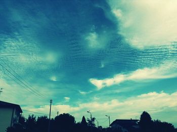 Low angle view of power lines against blue sky