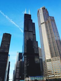 Low angle view of willis tower and modern buildings against sky