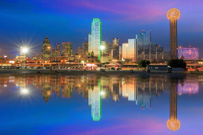 Reflection of illuminated buildings in city at night