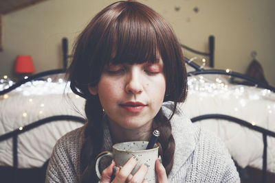 Portrait of young woman drinking drink