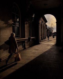 Woman walking on covered walkway