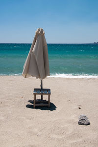 Lifeguard hut on beach against sky