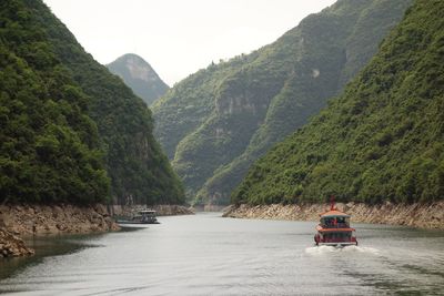 Scenic view of river amidst mountains against sky