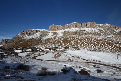 Low angle view of snow covered mountain against sky