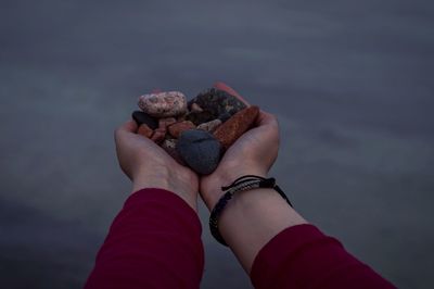 Close-up of woman hand holding sea