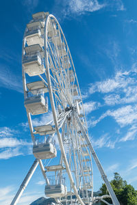 Big ferris wheel agains a blue sky with white clouds in luino