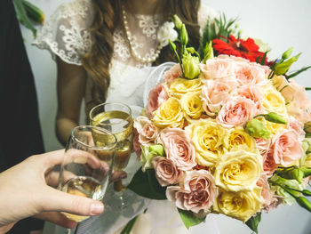 Close-up of woman holding bouquet of roses