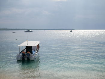 People in sea against sky