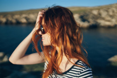 Rear view of woman against sea