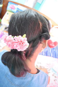 Close-up portrait of woman with pink flower