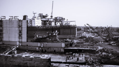 Construction site in city against clear sky